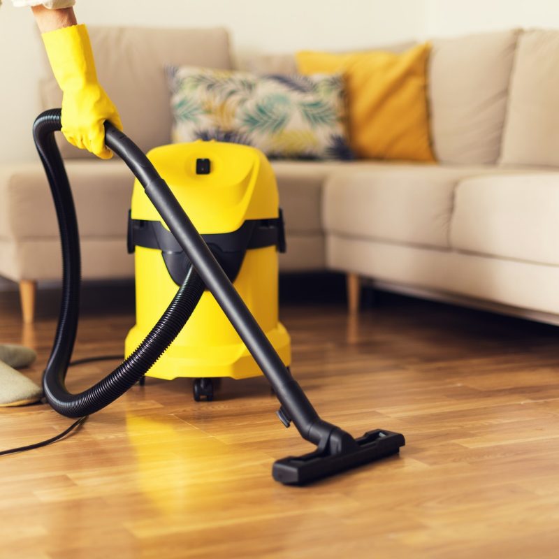 woman-cleaning-sofa-with-yellow-vacuum-cleaner-copy-space-cleaning-service-concept-1